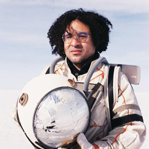 Close-up of Everton Vidal Azevedo wearing an astronaut suit at the Salar de Uyuni. Photo by Marvin Montes.